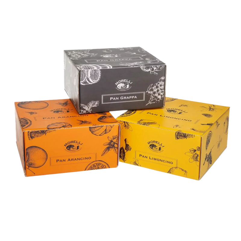 Ensemble de boîtes colorées de panettone artisanal avec différentes saveurs : Grappa, Arancino, et Limoncino, représentant la diversité de la gamme Morelli.