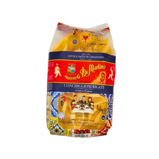 Paquet de Conchiglioni Rigati 500g de Pastificio Di Martino, avec illustration Dolce & Gabbana et aperçu des pâtes à travers la fenêtre transparente
