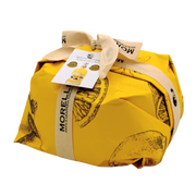 Panettone au limoncello emballé dans un packaging jaune Morelli, mettant en valeur le savoir-faire artisanal italien avec citron sicilien et ingrédients toscans.